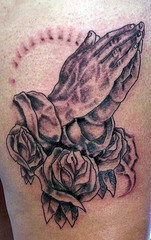 Praying hands and roses tattoo