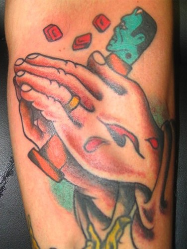 Praying hands with gum tattoo