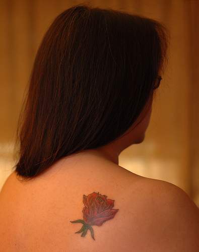 Red rose tattoo on shoulder