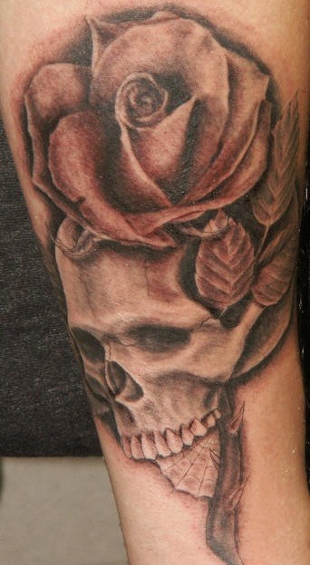 Detailed rose and skull tattoo