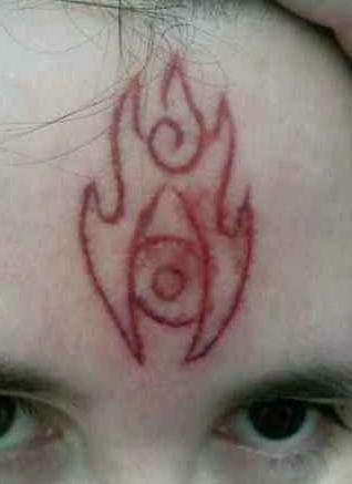 Skin scarification fire symbol on forehead