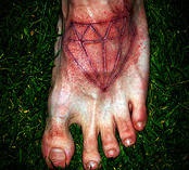 Bloody skin scarification diamond on foot