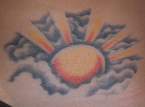 Shining sun in clouds  tattoo