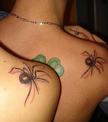 Shoulder tattoo, big black spiders,green clover
