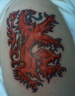 Shoulder tattoo, red monster like a lion, blue tongue