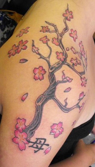Shoulder tattoo, tall tree with many flowers