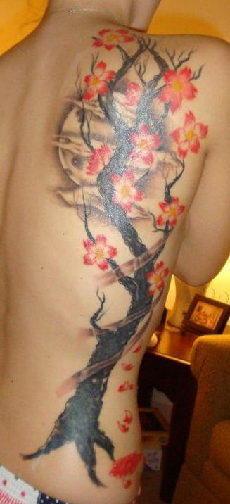 Side tattoo, black, tall tree with beautiful red flowers