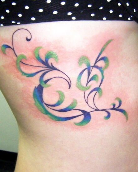 Side tattoo, overflowing from blue to green plant