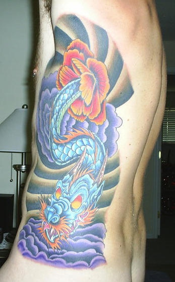 Side tattoo, whiskered, blue monster dragon, watching out of flower