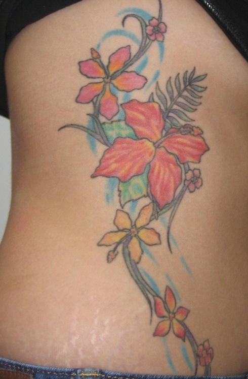 Side tattoo, beautiful red and yellow styled flowers