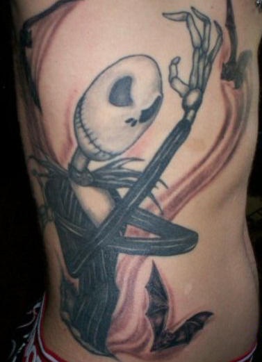 Side tattoo, angry skull, showing its  fist