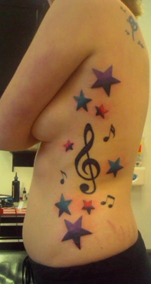 Side tattoo, treble clef with stars and melodies