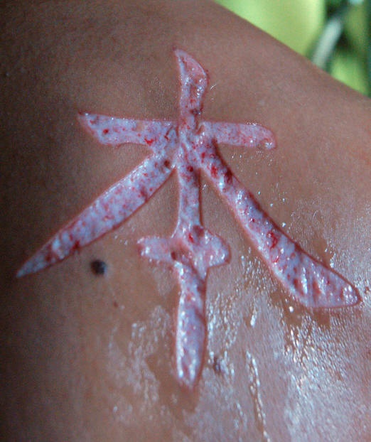 Skin scarification chinese hieroglyph