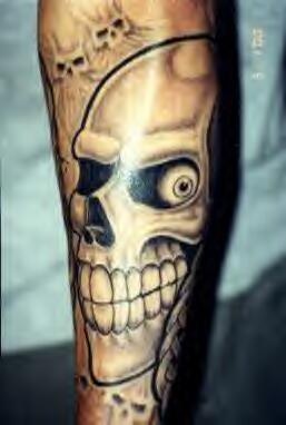 Smiling skull tattoo on arm
