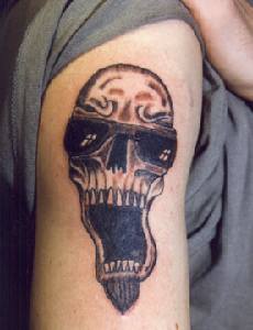 Curved skull in glasses tattoo