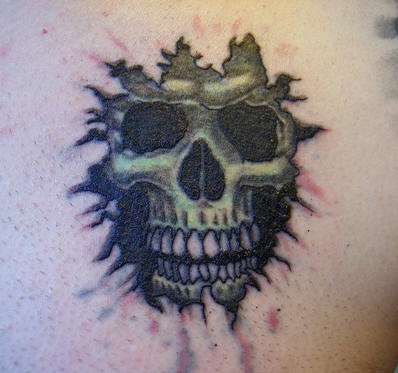 Skull under skin rip tattoo