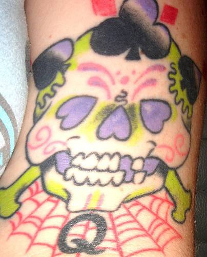 Sugar skull with suites tattoo