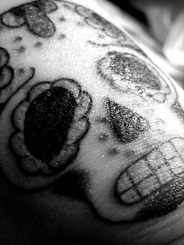 Black ink sugar skull tattoo