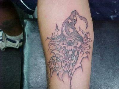 Skull in wizard cap tattoo