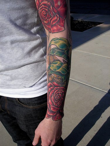 Red rose themed sleeve tattoo