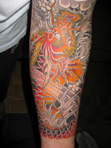 Colourful asian themed sleeve tattoo with dragon