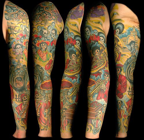 Dia de muertos themed sleeve tattoo