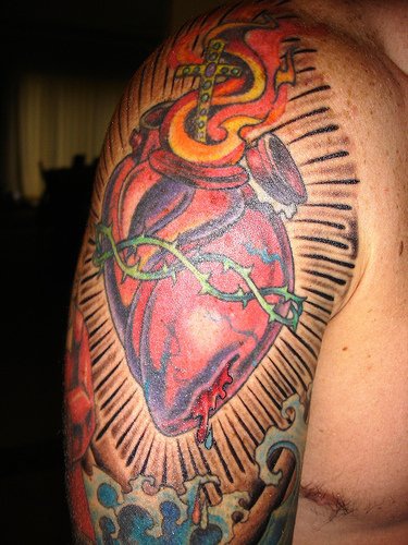 Detailed sacred heart tattoo on sleeve