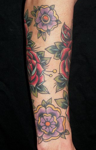 Colourful flowers sleeve tattoo