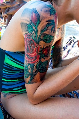 Realistic red rose sleeve tattoo