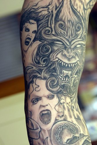 Demonios en tinta negra tatuaje en la manga