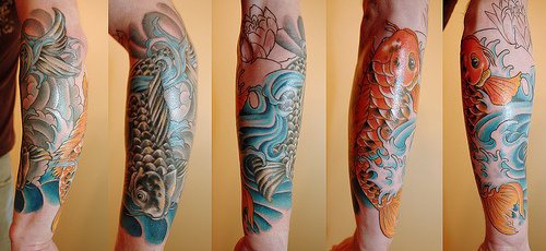 Red and black koi fishes tattoo