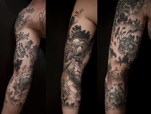 Black lotus themed sleeve tattoo