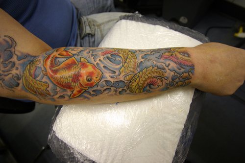 Asian koi coloured sleeve tattoo