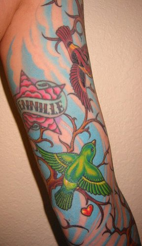 Colourful birds on tree sleeve tattoo