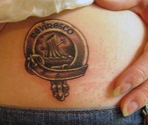 Small family crest black ink tattoo