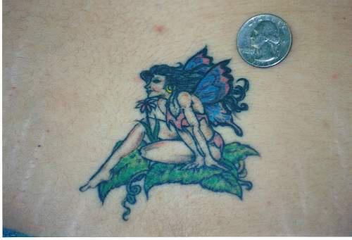 Small fairy on leafs tattoo