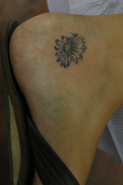 Small flower tattoo on ankle