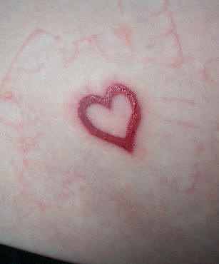 Small red heart tattoo