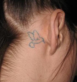 Small hummingbird tattoo behind the ear