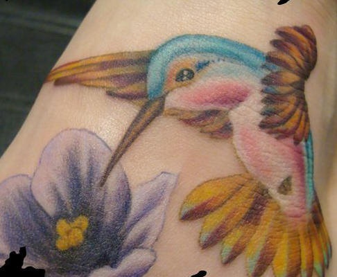 Small hummingbird in details tattoo