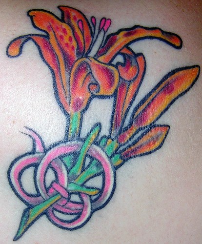Small lily flower in knot  tattoo