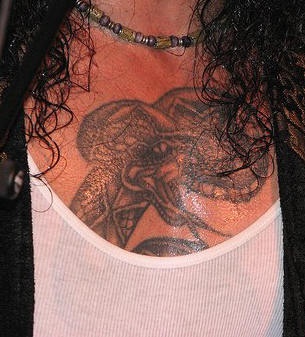 Black ink snake tattoo on chest