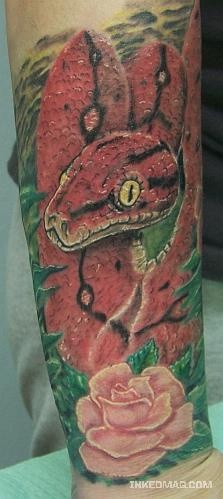 Realistic red snake with flower tattoo