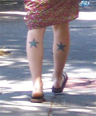 Black stars tattoo on both legs