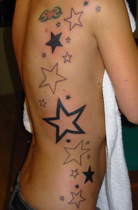 Tattoo on ribs, many, different stars, heart