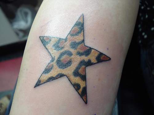 Star with leopard texture tattoo