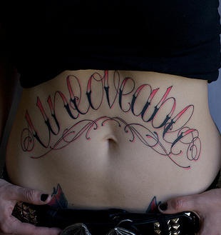 Stomach tattoo, unloveable, designed, red and black  inscription