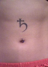 Stomach tattoo, little cross with tail, hieroglyph