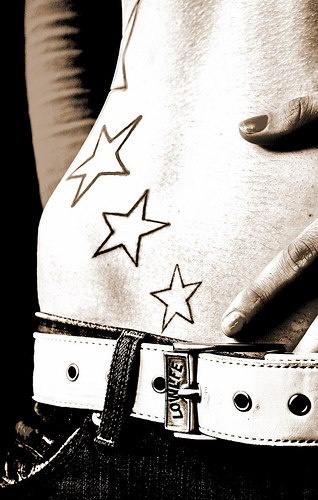 Stomach tattoo, stream of many unfilled stars