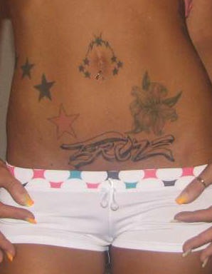 Stomach tattoo, designed inscription, flower, stars